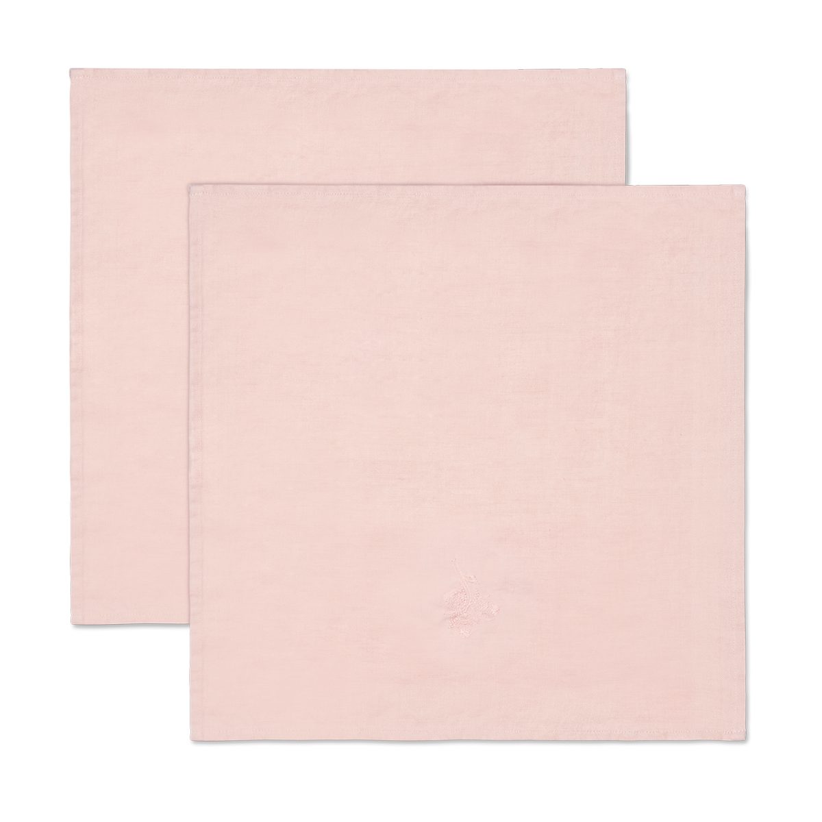 Fin linserviett med brodert motiv av hasselnøtt og fisk.